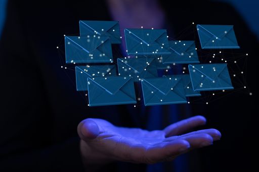 An abstract shot of a man's hand showing 3D rendered digital email and message icons on the web
