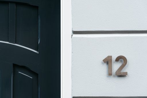 Classic green door with number 12. Vintage style