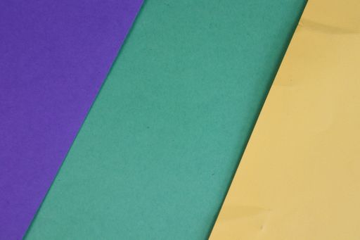 Colorful cardboards with diagonal stripes in purple, teal, and yellow tones.