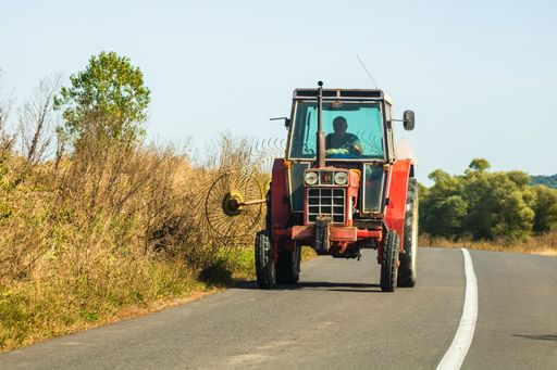 An agricultural tractor on road in Viscri. Bucharest, Romania, 2021
