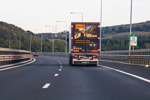 A loaded European truck in motion on asphalt road in Bucharest, Romania, 2020