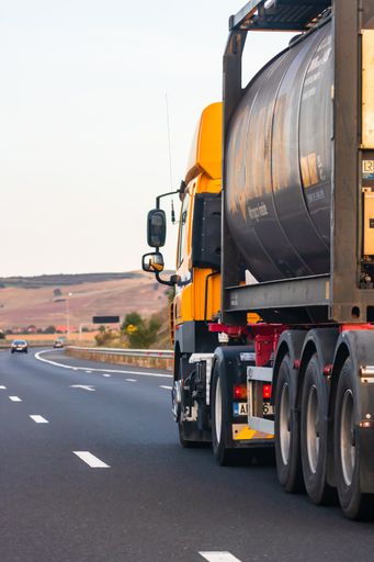 A loaded European truck in motion on asphalt road in Bucharest, Romania