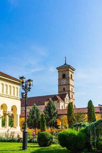 A vertical shot of Orthodox and catholic cathedral on a sunny day in Alba Iulia, Romania, 2021