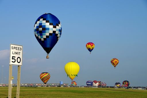 A beautiful view of the colorful hot air balloons in the blue sky during a festival in Kansas City