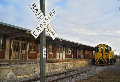 A railroad crossing sign at a station in Kansas city