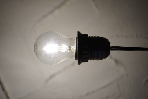 A vertical shot of a hanging lightened lamp