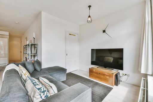 A cozy area with a comfortable sofa and TV set in a modern apartment
