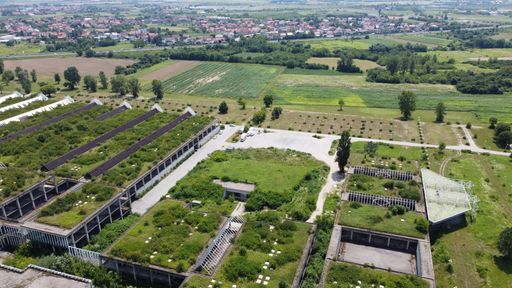 An aerial view of buildings with green roofs