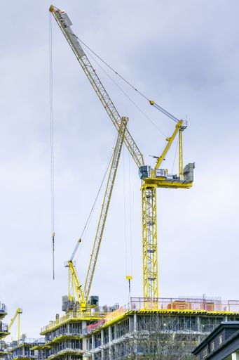 A vertical shot of a large yellow construction crane