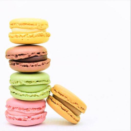 A vertical shot of colorful macaroon biscuits isolated on the white background
