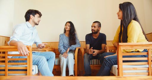 A closeup shot of a four South Asian friends in a house gathering together in India