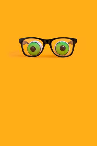 the Halloween concept with eyeglasses and human doll eyeballs