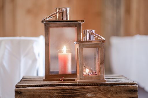 The two candle lanterns on a wooden table for a wedding decoration