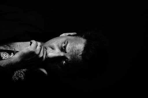 The grayscale portrait of a man in the dark room