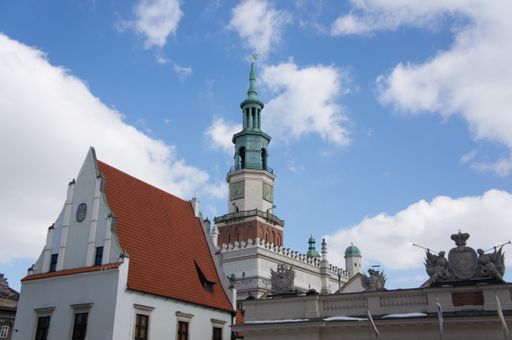 The town hall clock tower in Poznan Poland against a cloudy sky