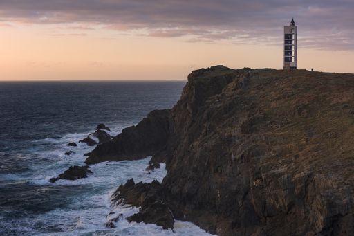 A wide angle shot of the Valdovino lighthouse in Galicia during a sunset