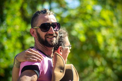 Portrait of two happy young man embraced walking in a park