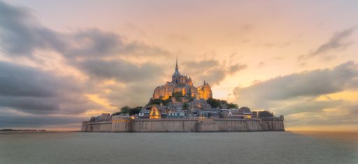 A stunning view of the Le Mont-Saint-Michel walled city at sunset, France