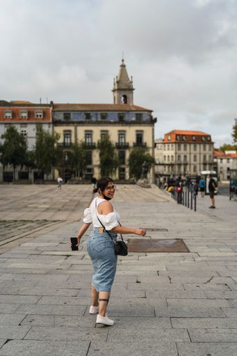 A vertical back view of a Caucasian female walking in Spain