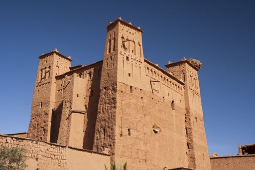 A low angle shot of a beautiful old castle under the clear blue sky captured in Morocco