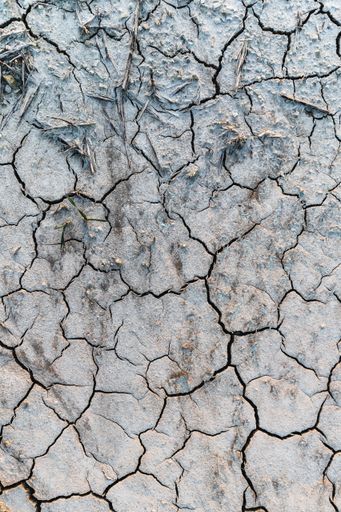 A vertical high angle shot of desertified land covered with snow