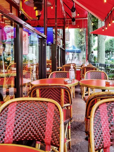 A vertical shot of a street view, traditional classic Parisian French cafe