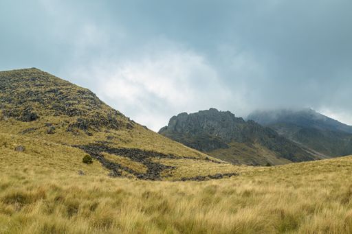 A grassy slope and a mountain in the background at the Nevado de Toluca National Park in Mexico