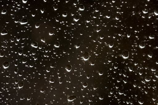 A beautiful shot of the waterdrops on the glass of a window - perfect for background