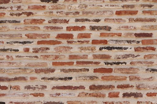 A closeup of a brick wall under the sunlight at daytime - perfect for backgrounds and wallpapers