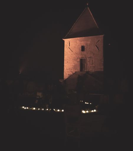 A vertical shot of a tower at night.