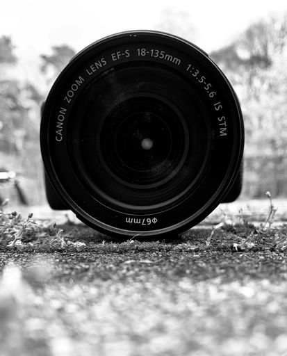 A close-up of the camera lens from Canon on the ground.