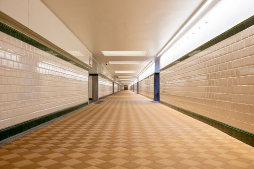 A breathtaking view of a long corridor decorated with lots of  white lights