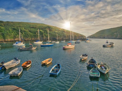 The sun setting on Solva Harbour in Pembroleshire, Wales