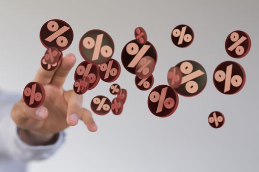 A male pointing at sales icons floating in the air