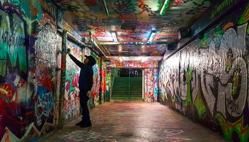 A Graffiti Artist Spraypaints Wall in Sydney Uni's Public Grafitti Tunnel, Sydney, Australia
