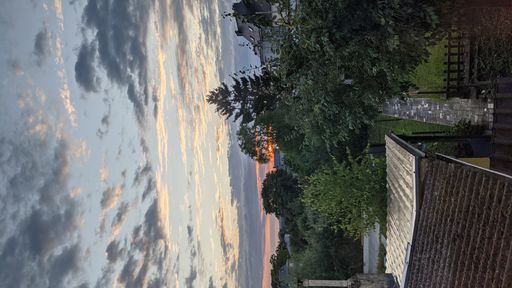 A beautiful view of a green landscape gleaming under the sunset