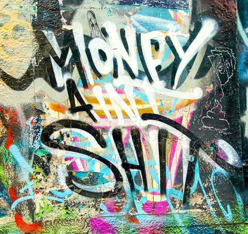 A colourful Grafitti Street Art Phrase on Wall in Newtown Suburb Laneway, Sydney, Australia