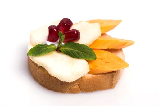 A closeup shot of delicious canape with feta cheese isolated on white background