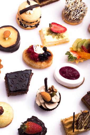 Different sweet canapes on a white table