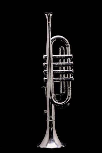 A vertical shot of a silver Trumpet isolated on a black background