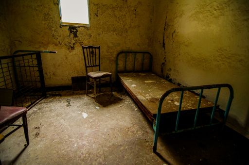 A high angle shot of an abandoned cell room in Spain