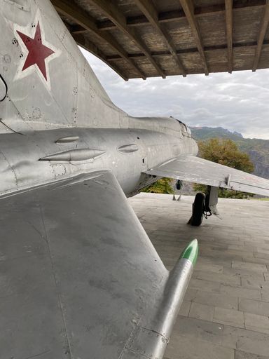 A vertical shot of a military aircraft with a star under the roof