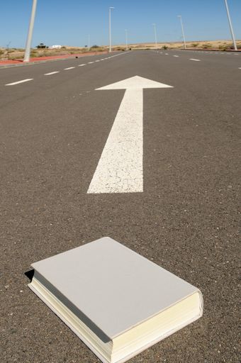 A closeup shot of a grey book in the middle of a road in Spain