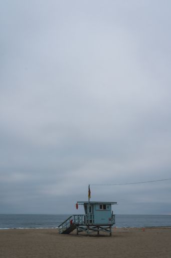A vertical shot of a communication station on the beach under a clouded sky in San Francisco, USA