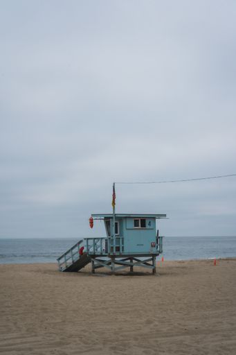 A vertical shot of a communication station on the beach under a clouded sky in San Francisco, USA