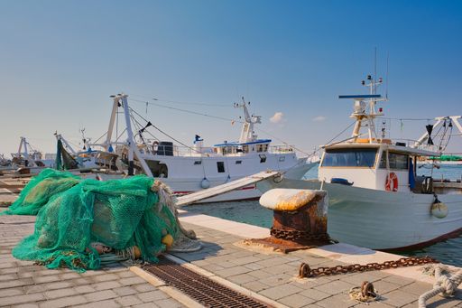 View of the typical fishing boats and fishing nets in the port of Manfredonia in the Apulia region in southern Italy
