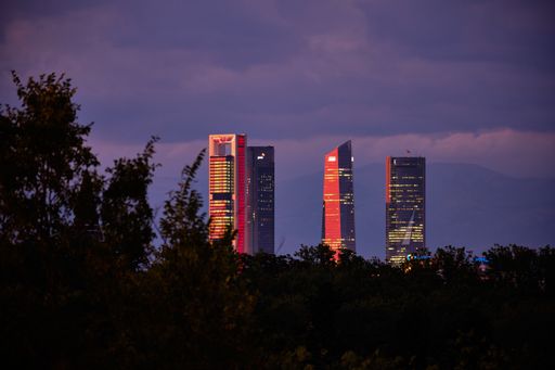 A beautiful shot of pink sunset over the illuminated skyscrapers in the evening
