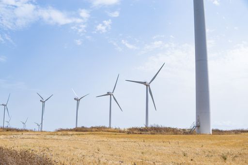 Green energy concept, eco power. Wind turbine located along the hill , moving with the wind