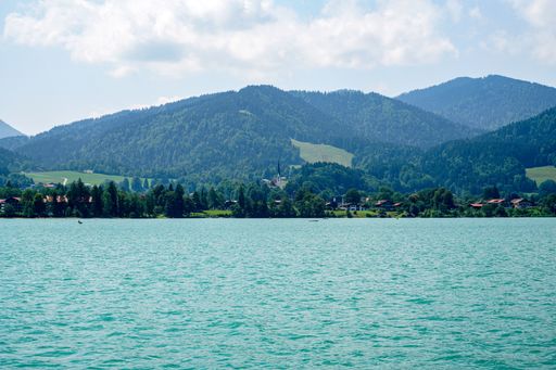 A beautiful view of the Bavarian Tegernsee lake and its shores with mountains in the background
