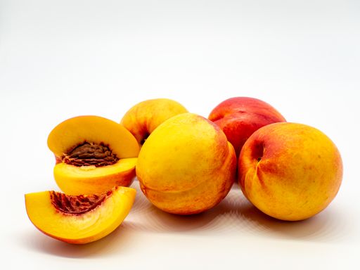 A beautiful shot of peaches isolated on a white surface.